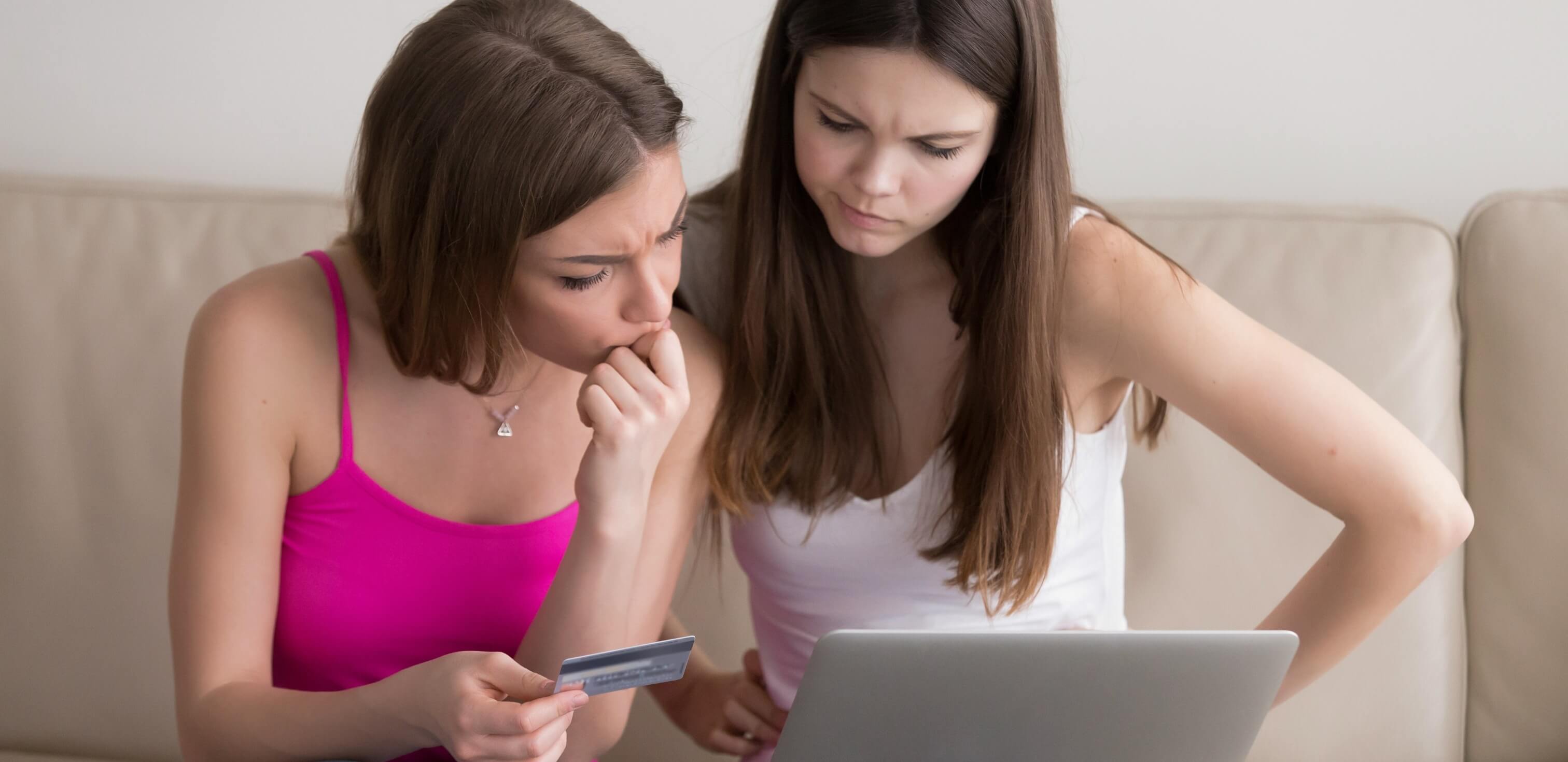 Erros gramaticais: duas meninas olhando para um computador com expressão de dúvida.