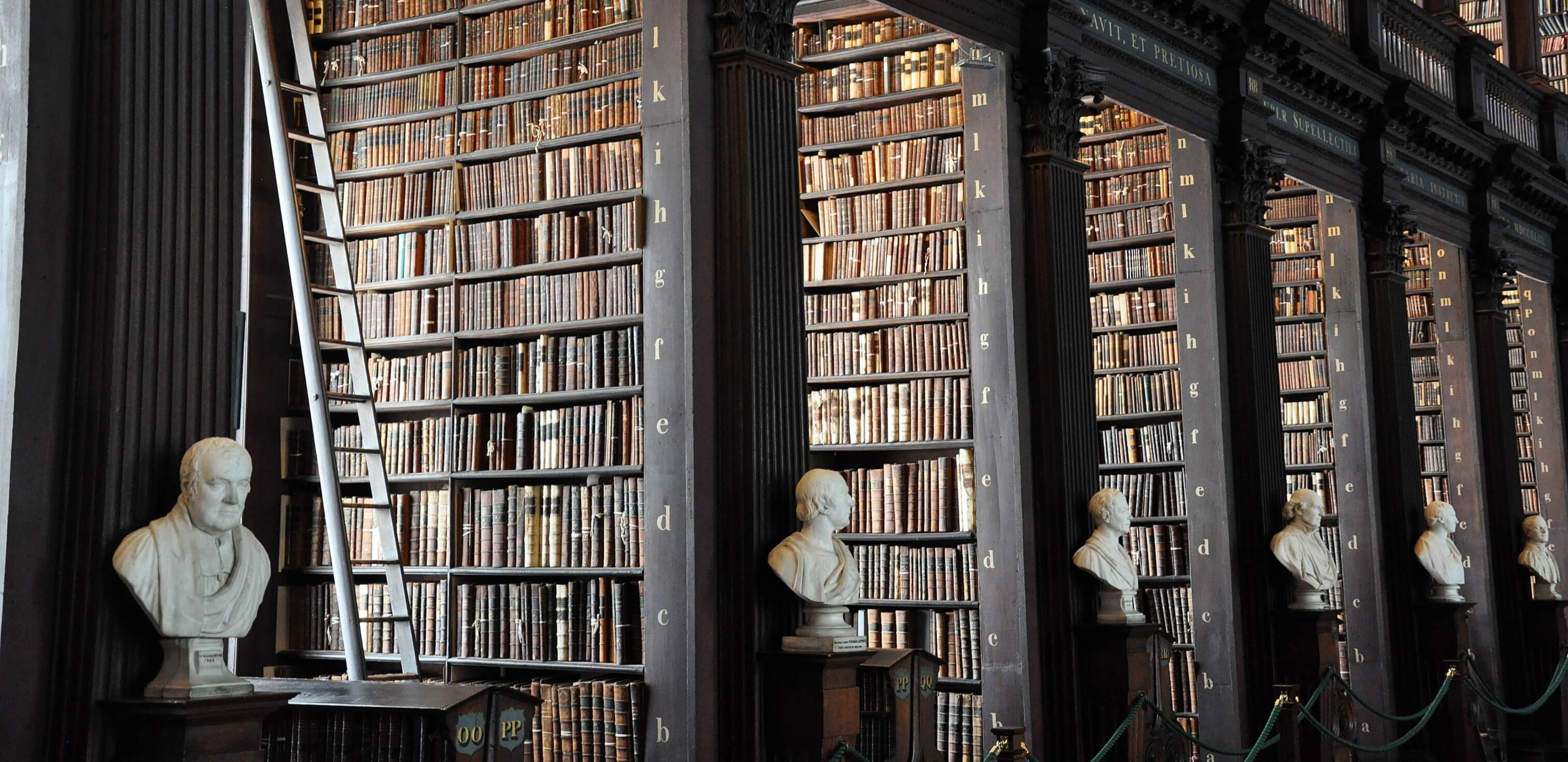 como usar citação na redação: imagem de uma biblioteca com bustos de grandes filósofos e escritores